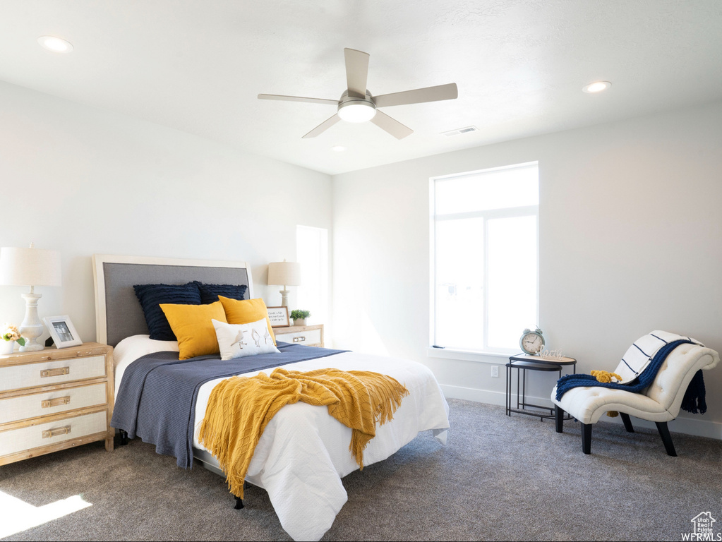 Carpeted bedroom with ceiling fan