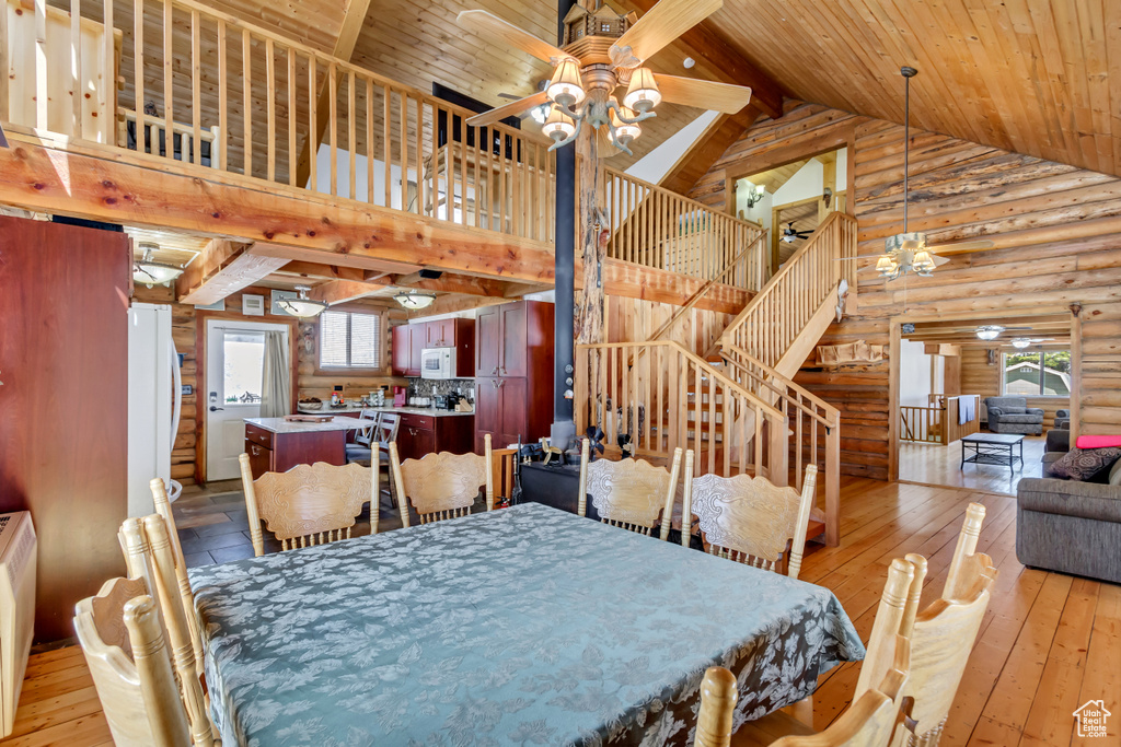 Dining area with wooden ceiling, light hardwood / wood-style flooring, a healthy amount of sunlight, and ceiling fan