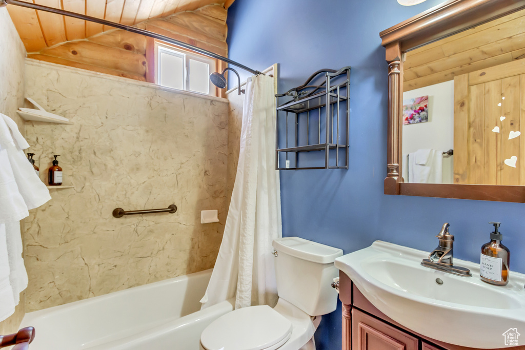 Full bathroom with toilet, shower / bathtub combination with curtain, vanity, and wooden ceiling