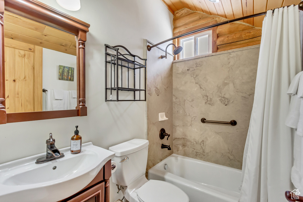 Full bathroom featuring lofted ceiling, wood ceiling, toilet, vanity, and shower / bath combo