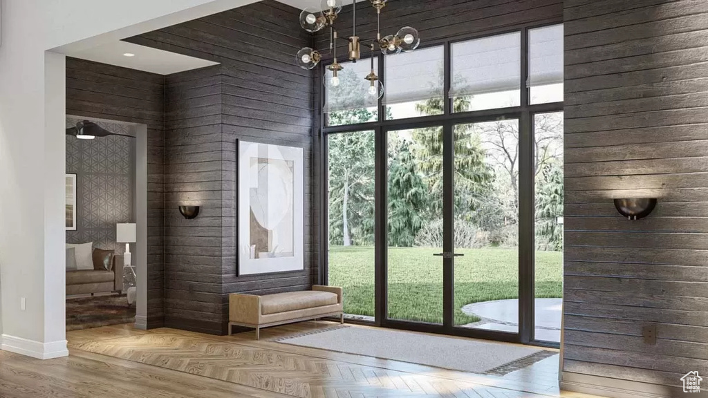 Doorway to outside with wooden walls, parquet flooring, and a high ceiling