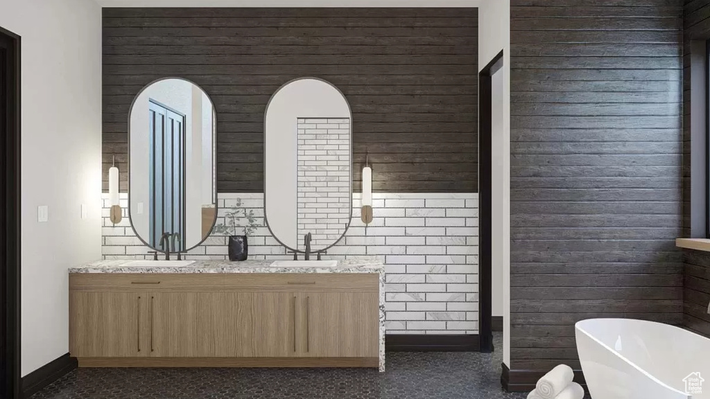 Bathroom featuring a tub and double sink vanity