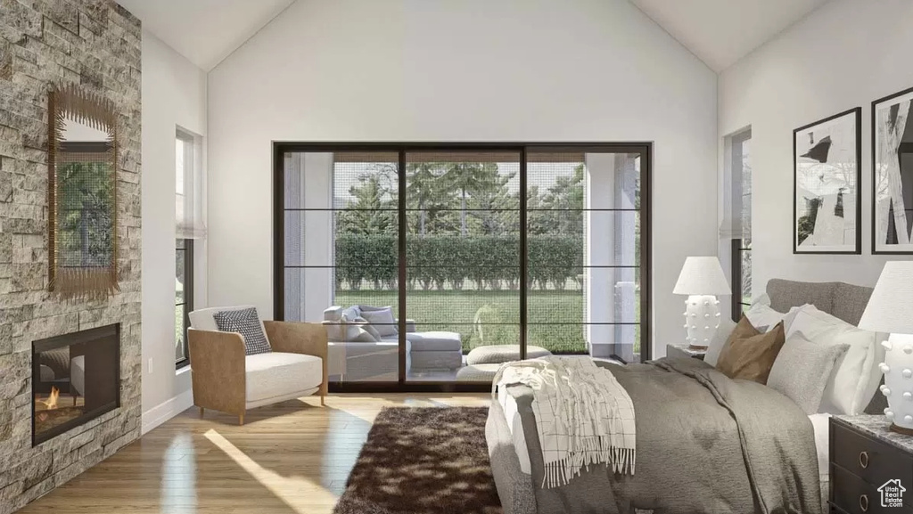 Bedroom with high vaulted ceiling, a stone fireplace, and light hardwood / wood-style flooring