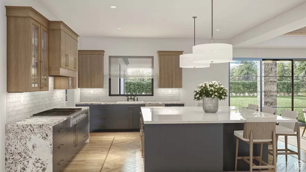 Kitchen featuring decorative light fixtures, backsplash, a center island, sink, and light parquet flooring