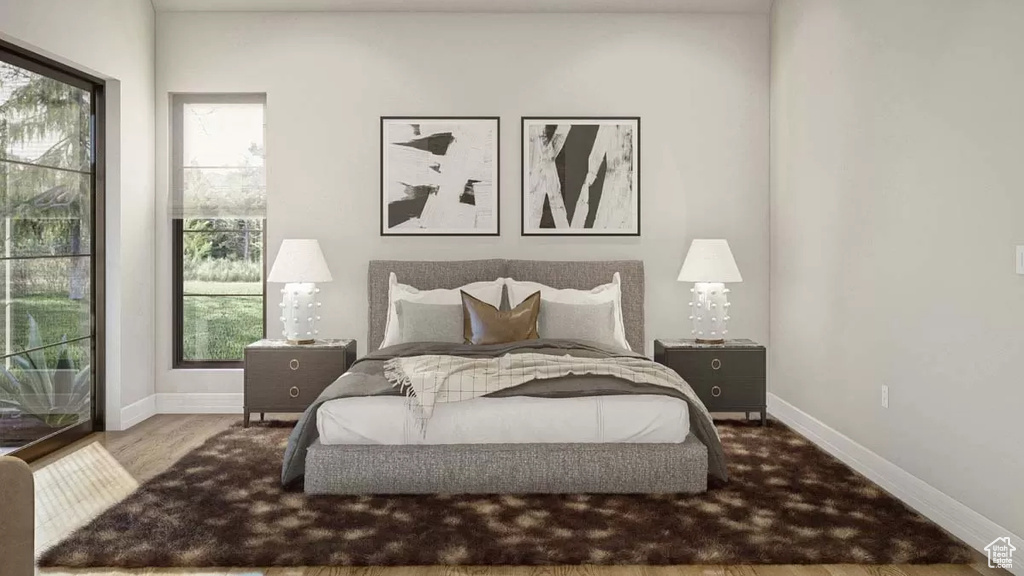 Bedroom featuring multiple windows and wood-type flooring