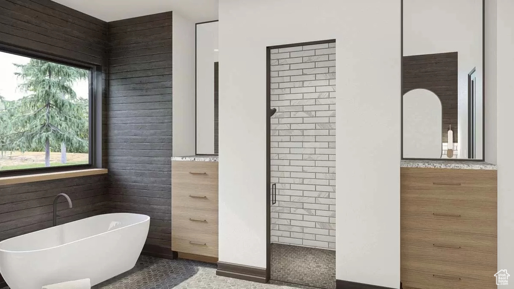 Bathroom featuring tile walls and plus walk in shower