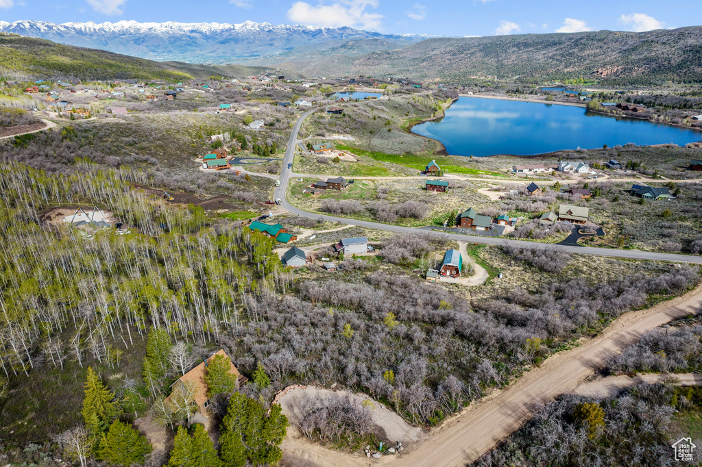 Drone / aerial view featuring a water and mountain view