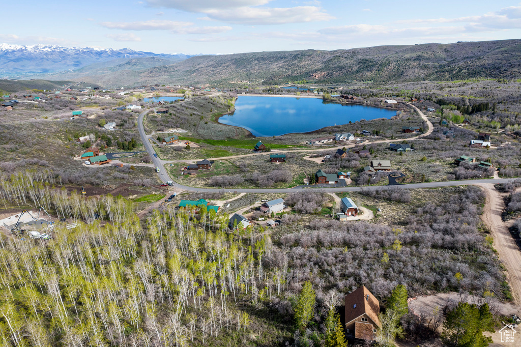 Aerial view featuring a water and mountain view