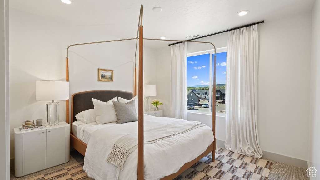 Bedroom featuring light colored carpet