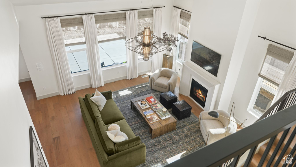 Living room with a high ceiling and hardwood / wood-style floors