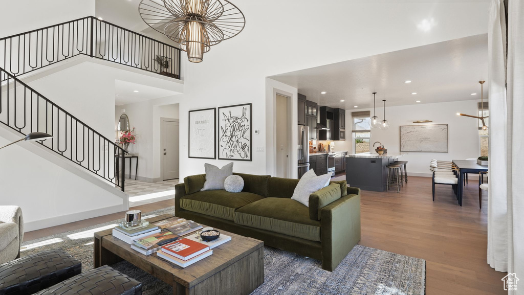 Living room with dark wood-type flooring and an inviting chandelier