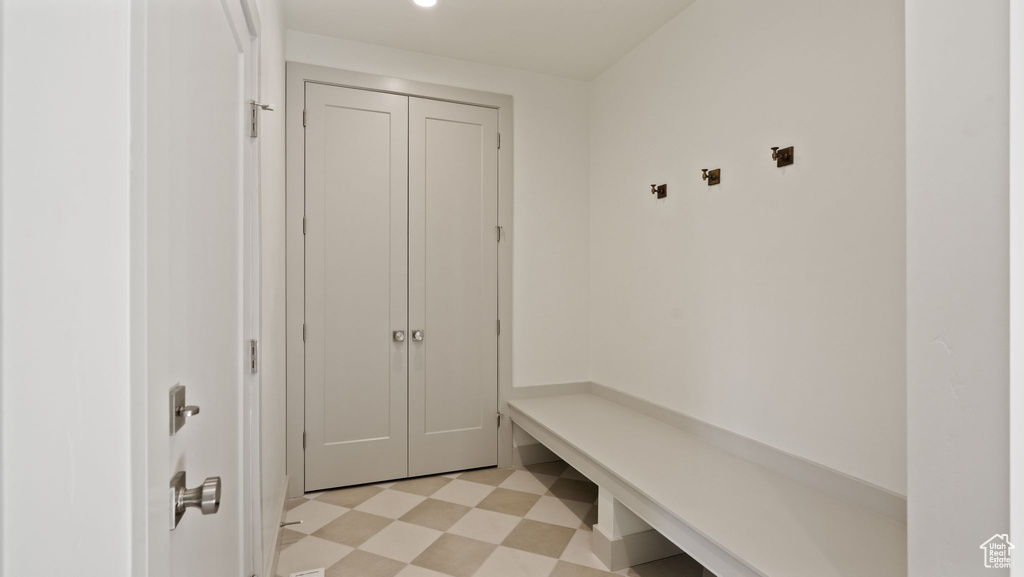 Mudroom featuring light tile flooring