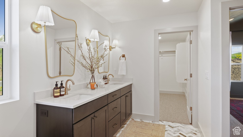 Bathroom with double sink and vanity with extensive cabinet space