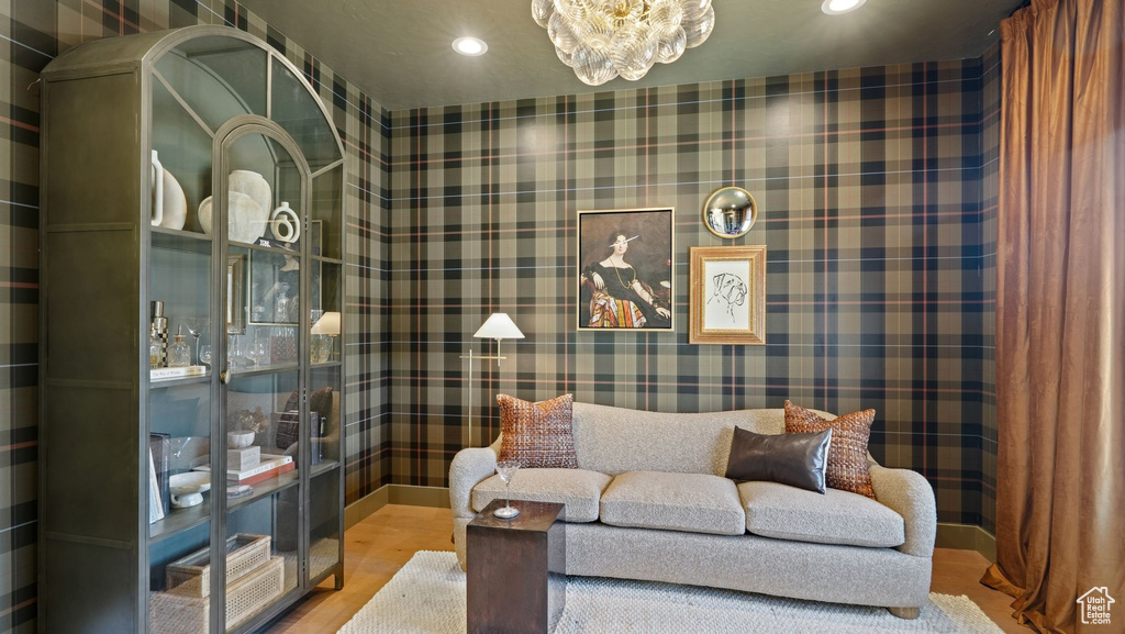 Sitting room with a notable chandelier and hardwood / wood-style floors