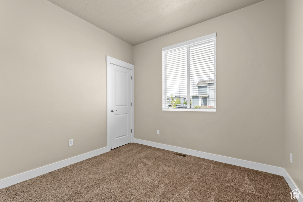 Unfurnished room with carpet floors