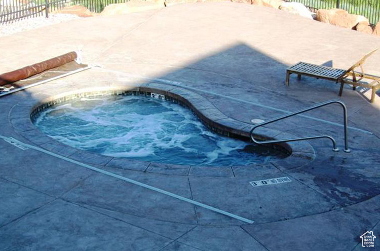 View of swimming pool with an in ground hot tub