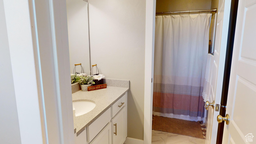 Bathroom featuring tile floors and large vanity