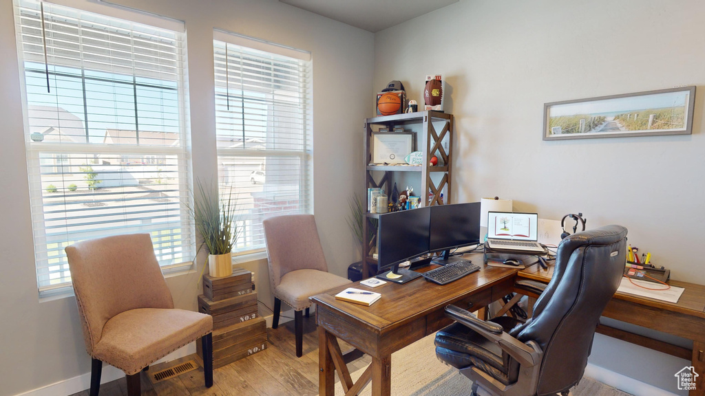 Office with hardwood / wood-style flooring