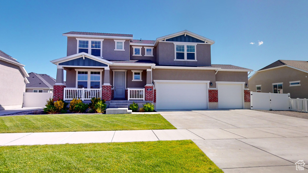 View of front of house featuring a front yard and a garage