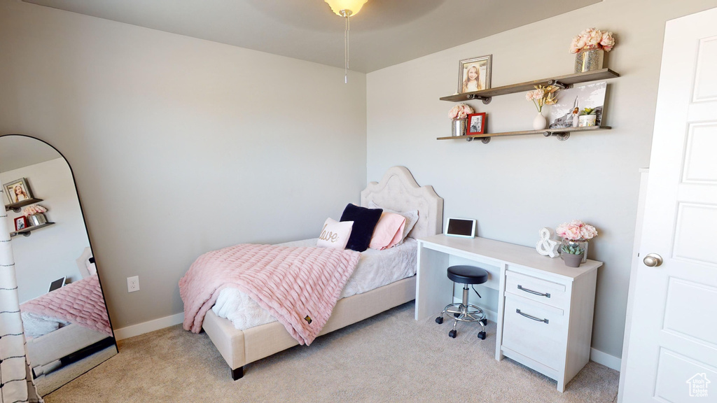 Bedroom featuring ceiling fan and light carpet