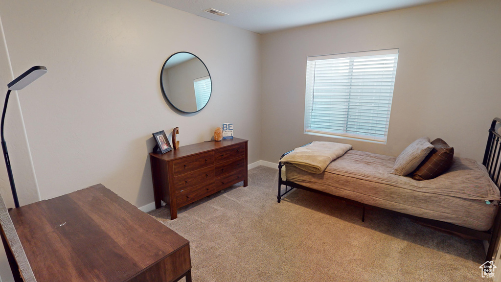 Bedroom featuring light colored carpet