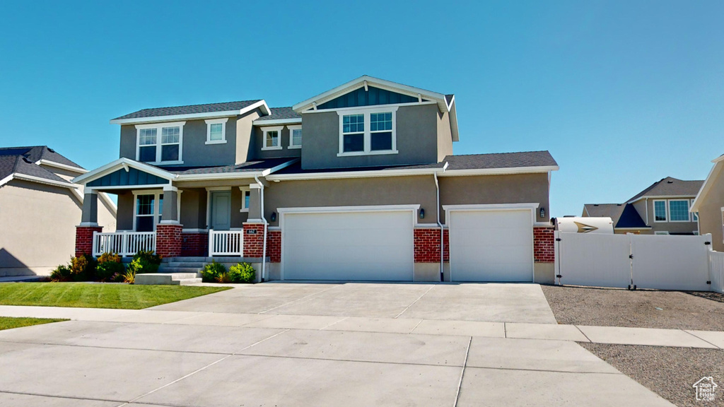 View of front of house featuring a garage and covered porch