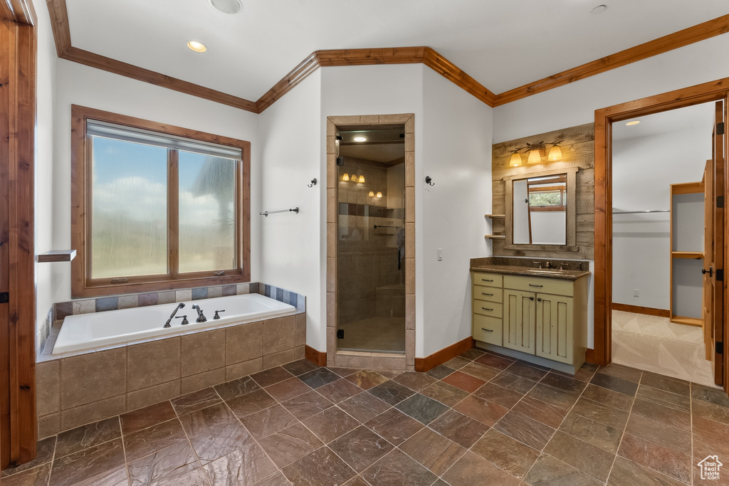 Bathroom with crown molding, tile flooring, independent shower and bath, and large vanity