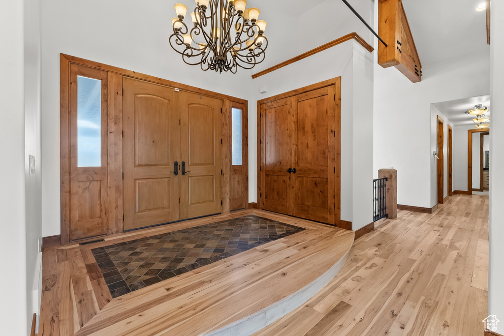 Entryway featuring a chandelier and light hardwood / wood-style flooring