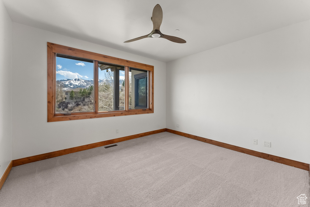 Spare room featuring ceiling fan and carpet floors