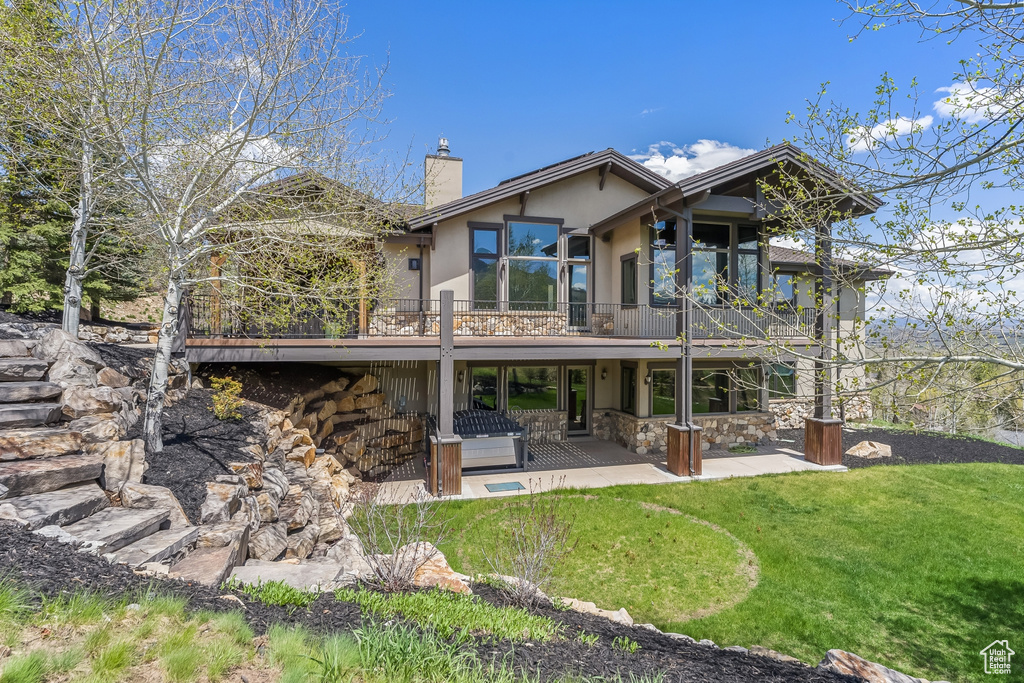 Back of house featuring a patio and a lawn