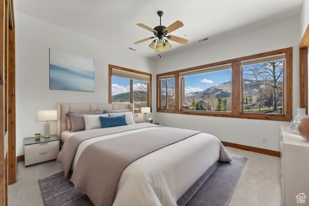 Bedroom with light carpet and ceiling fan