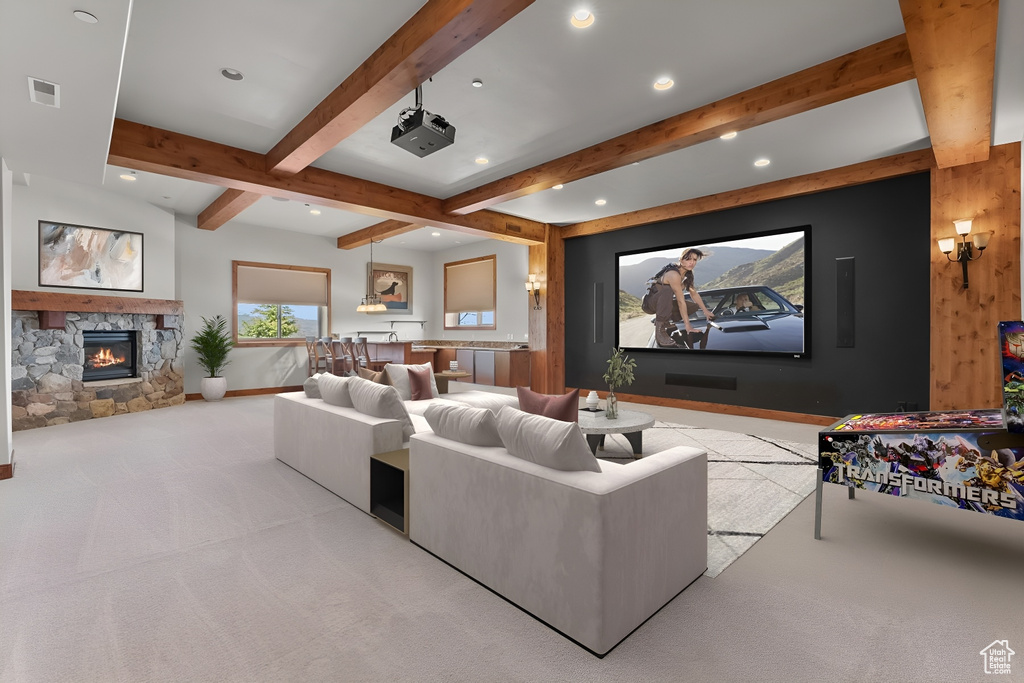 Interior space with carpet, a fireplace, and beamed ceiling