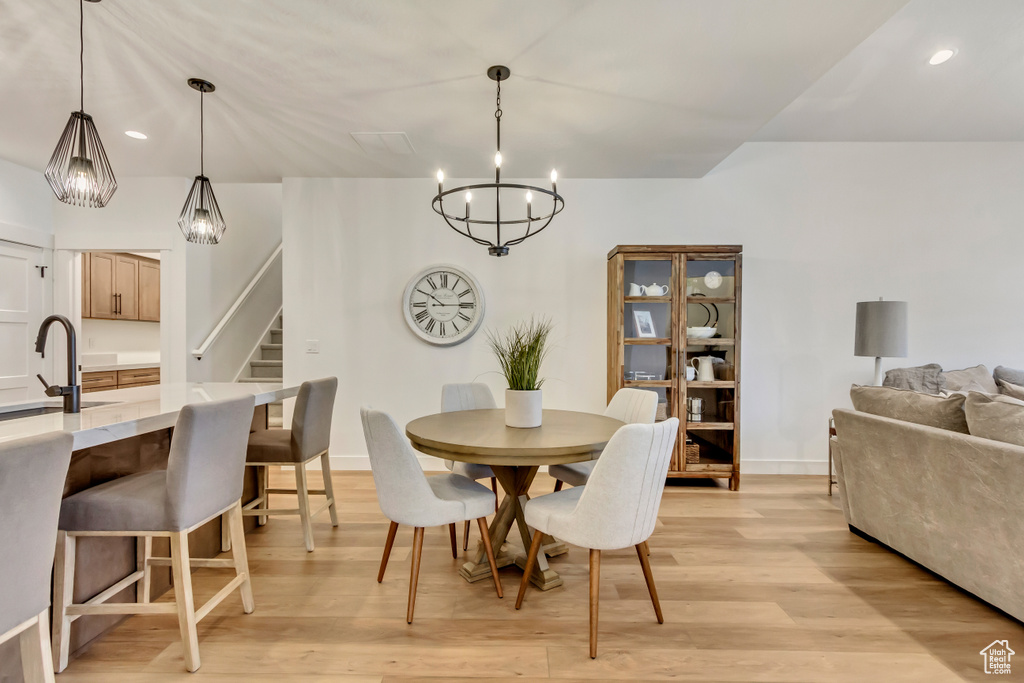 Dining space with sink and light hardwood / wood-style flooring