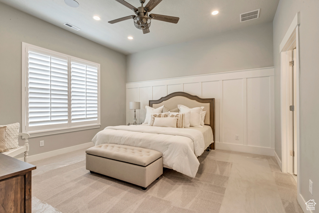 Carpeted bedroom featuring ceiling fan