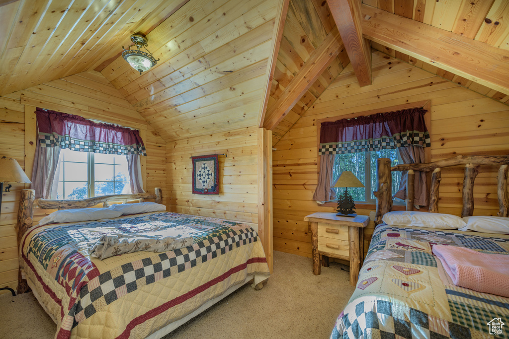 Bedroom with carpet flooring, wood ceiling, and vaulted ceiling with beams