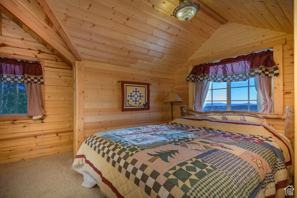 Bedroom featuring vaulted ceiling, wooden ceiling, and carpet floors