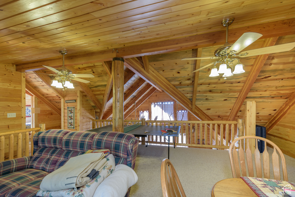 Carpeted bedroom featuring ceiling fan, lofted ceiling with beams, and wooden ceiling