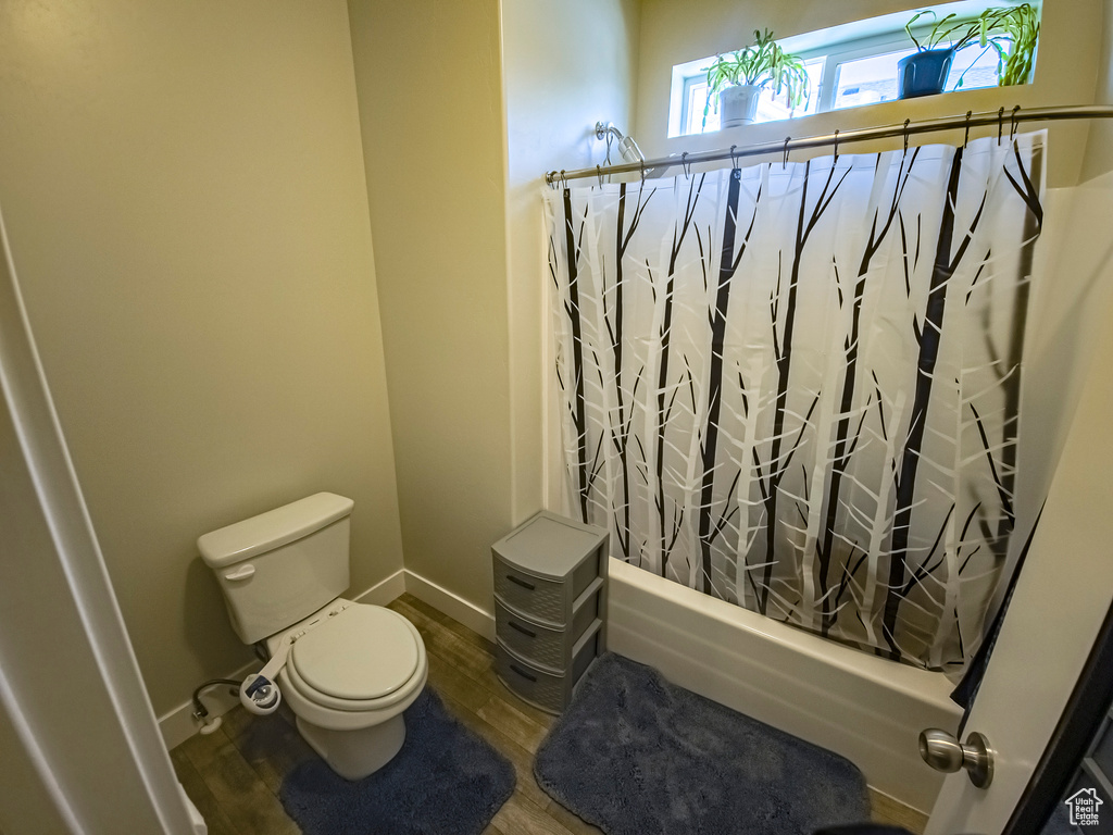 Bathroom featuring hardwood / wood-style flooring and toilet