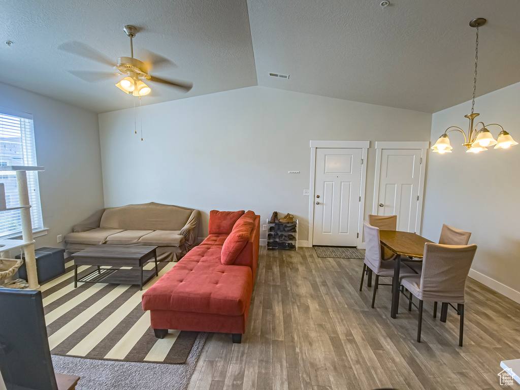 Living room featuring hardwood / wood-style flooring and vaulted ceiling