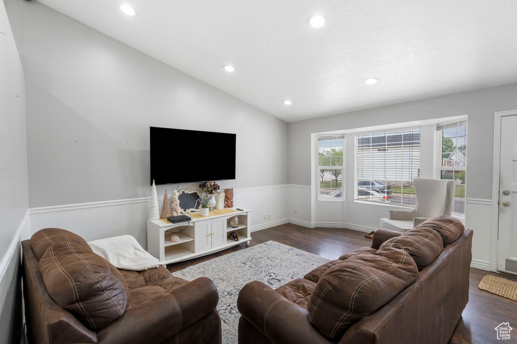 Living room featuring lofted ceiling and hardwood / wood-style floors