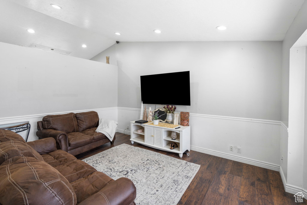 Living room featuring dark hardwood / wood-style floors and vaulted ceiling