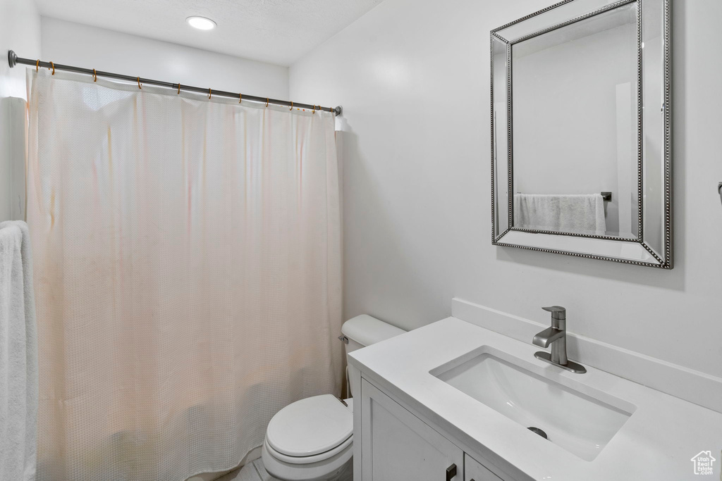 Bathroom with large vanity and toilet