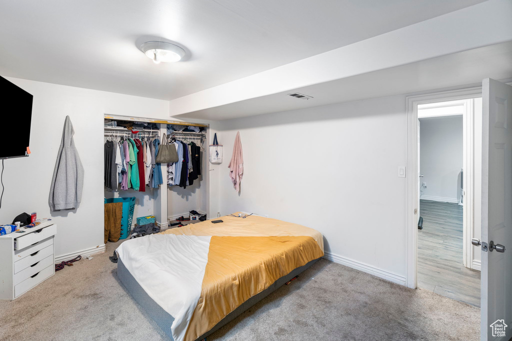 Bedroom with a closet and carpet floors