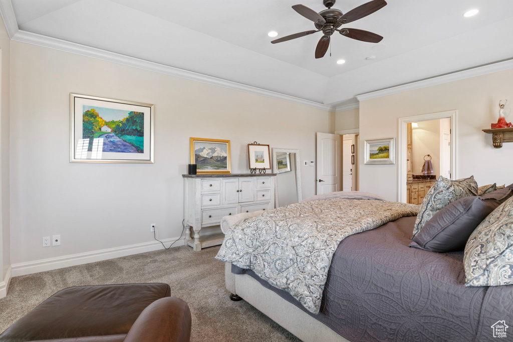 Carpeted bedroom featuring ensuite bath, ceiling fan, and ornamental molding