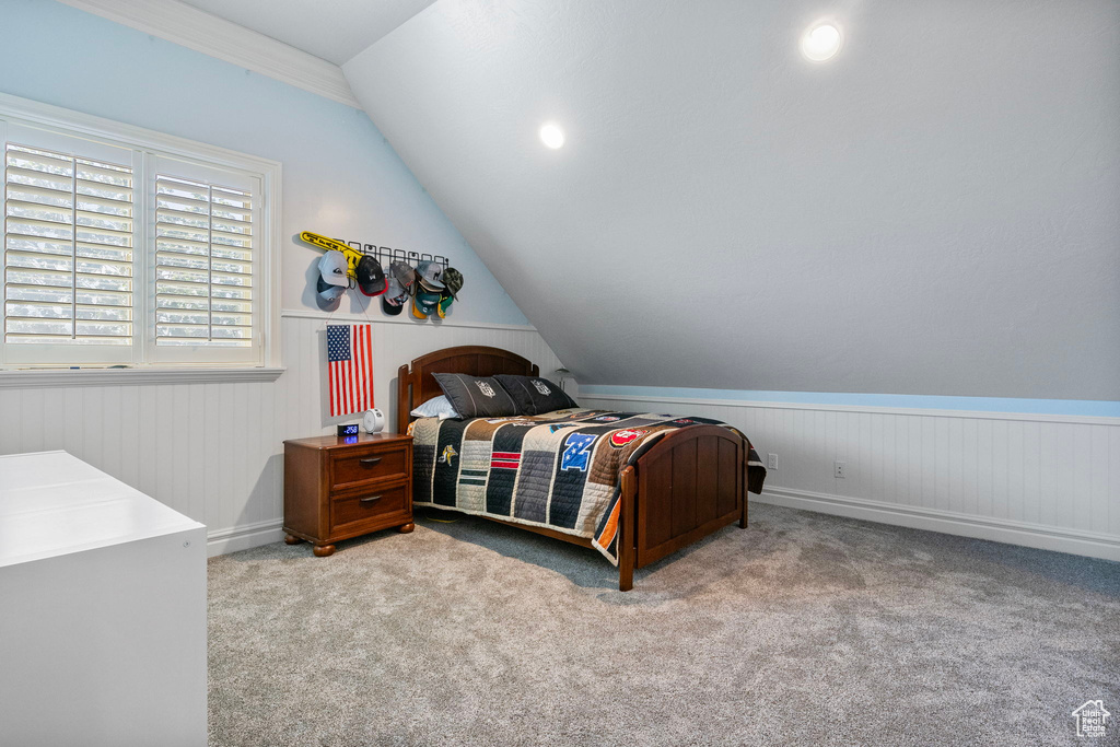 Bedroom featuring vaulted ceiling and light carpet