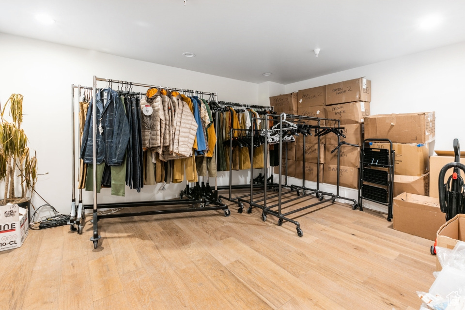 Workout area with light hardwood / wood-style floors