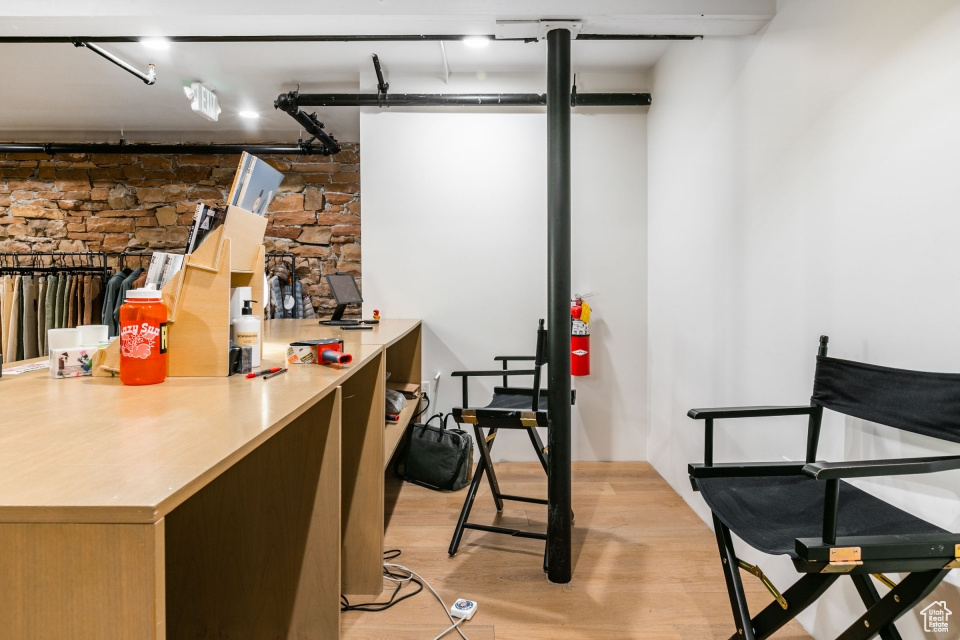 Interior space with light hardwood / wood-style floors, track lighting, and kitchen peninsula