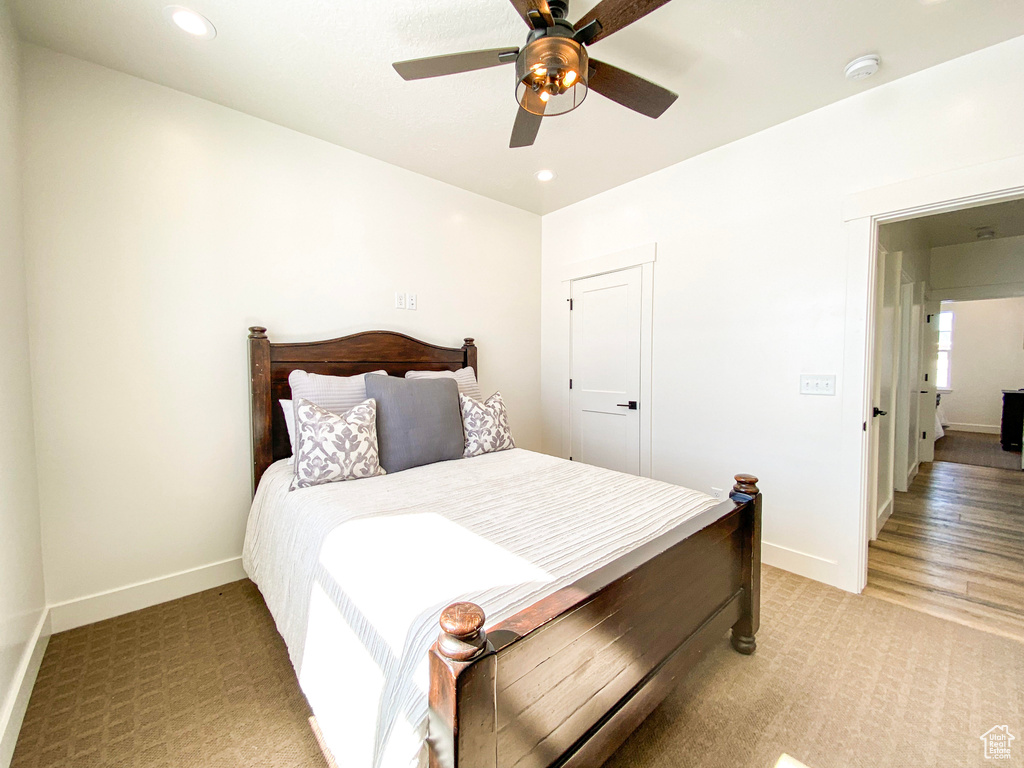 Carpeted bedroom with ceiling fan