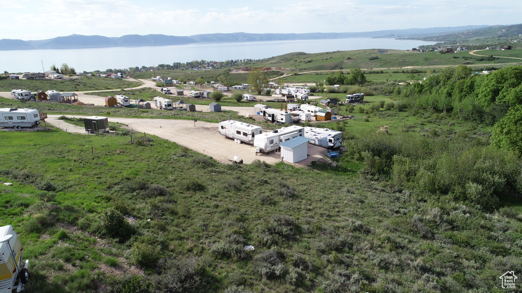 Birds eye view of property with a water and mountain view