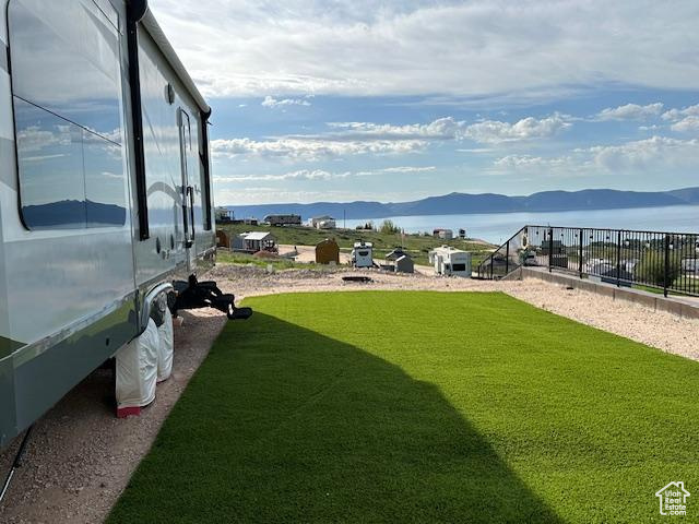 View of yard with a water and mountain view